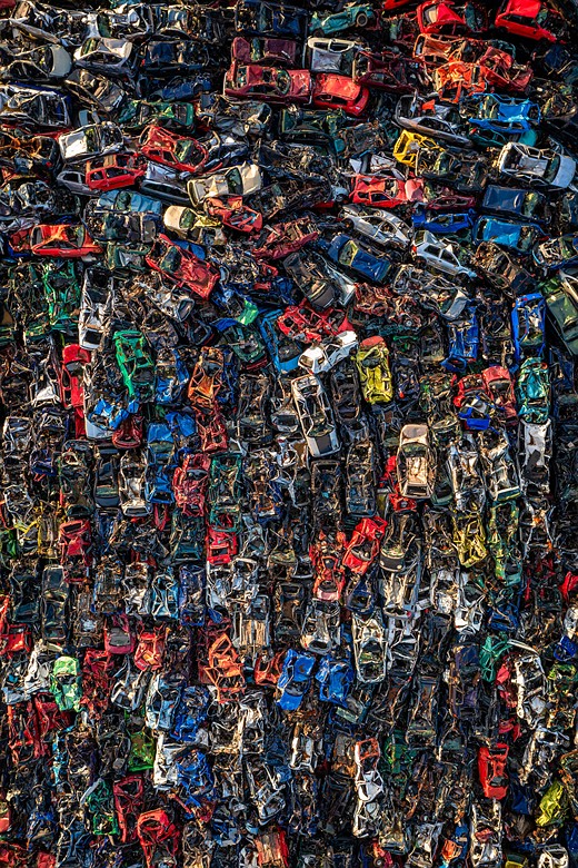 crushed colorful cars are piled together