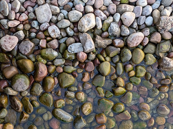 Photo-of-rocks-on-a-beach-where-water-meets-shore