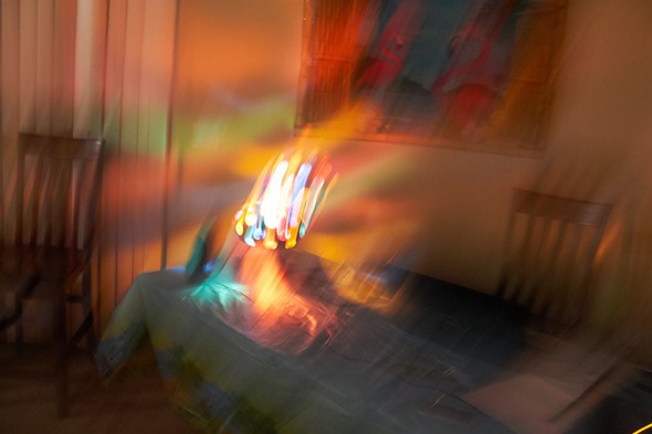 blurry photo of a multi-color orb projector sitting on a table
