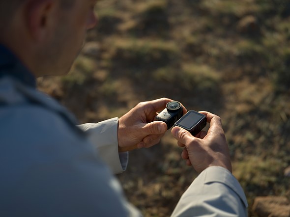 a man puts the dji osmo camera on the dock