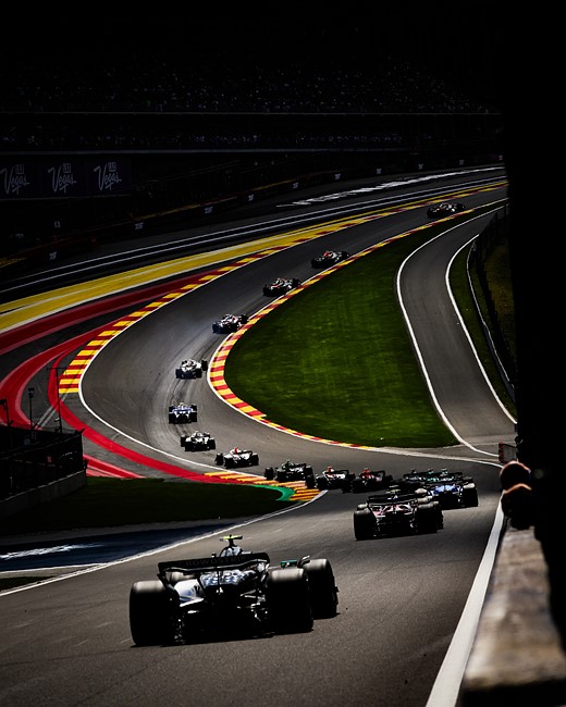 formula 1 cars line up on a curving track
